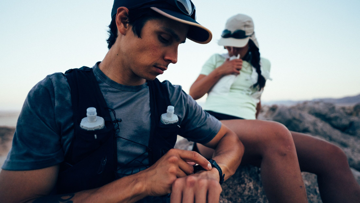 Lactate And Lactate Threshold Trail Runner Looking At Watch On Top Of Mountain Checking Lactate Threshold