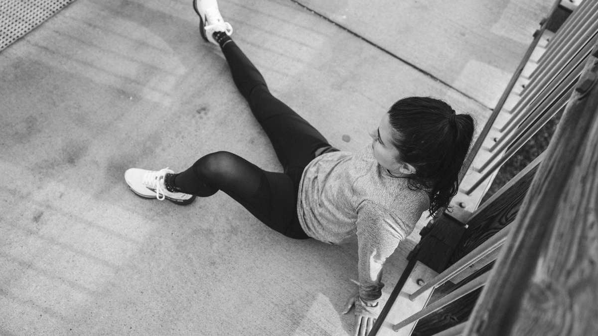 Reduce Jet Lag Female Runner Athlete Sitting On Ground Concrete Outside
