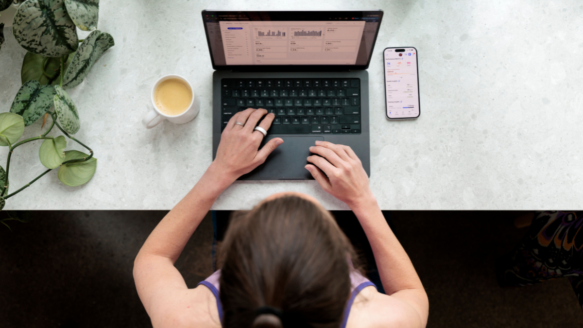 Athlete Using Trainingpeaks To Review Her Training Metrics On Her Computer And Phone After A Workout.