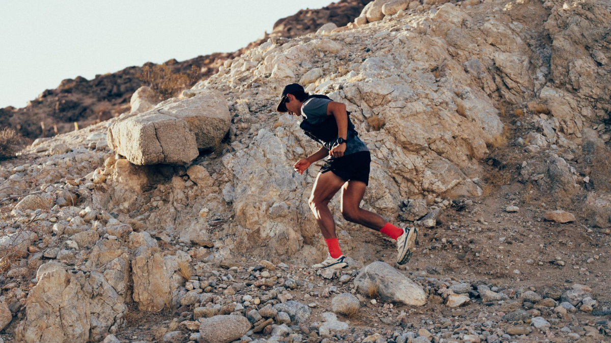 Technical Trail Running Man In Running Clothes And Hydration Pack Running Up A Technical Mountain Trail.