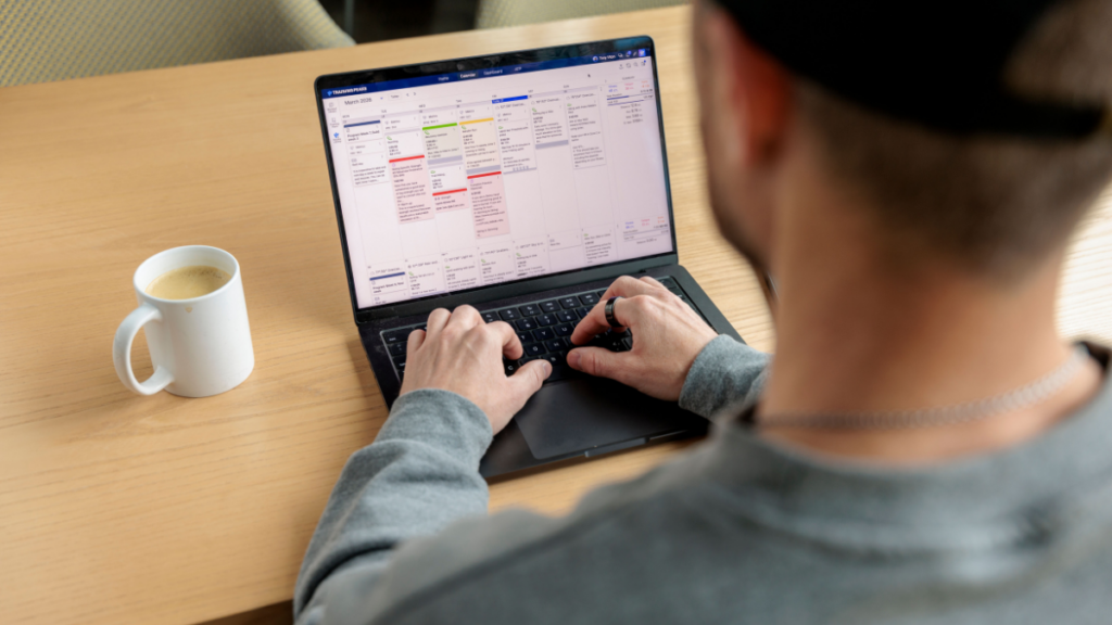 TrainingPeaks Coach creating Training Plan in TrainingPeaks Store sitting at desk on laptop