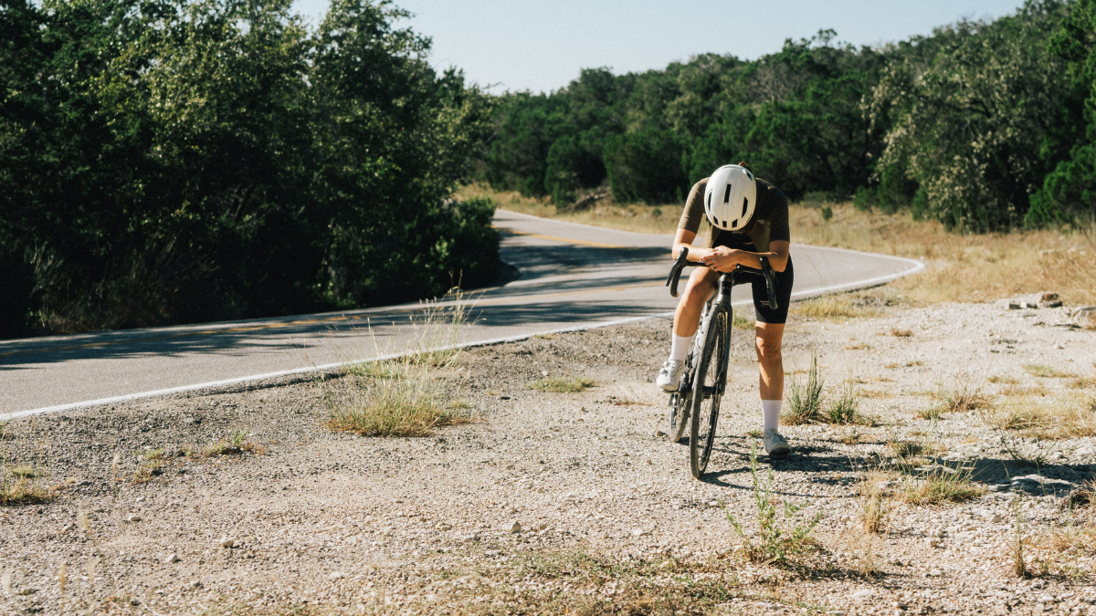 The 4 Signs Of Overtraining Female Gravel Cyclist Athlete Standing On Side Of Road After Hard Session Overtraining