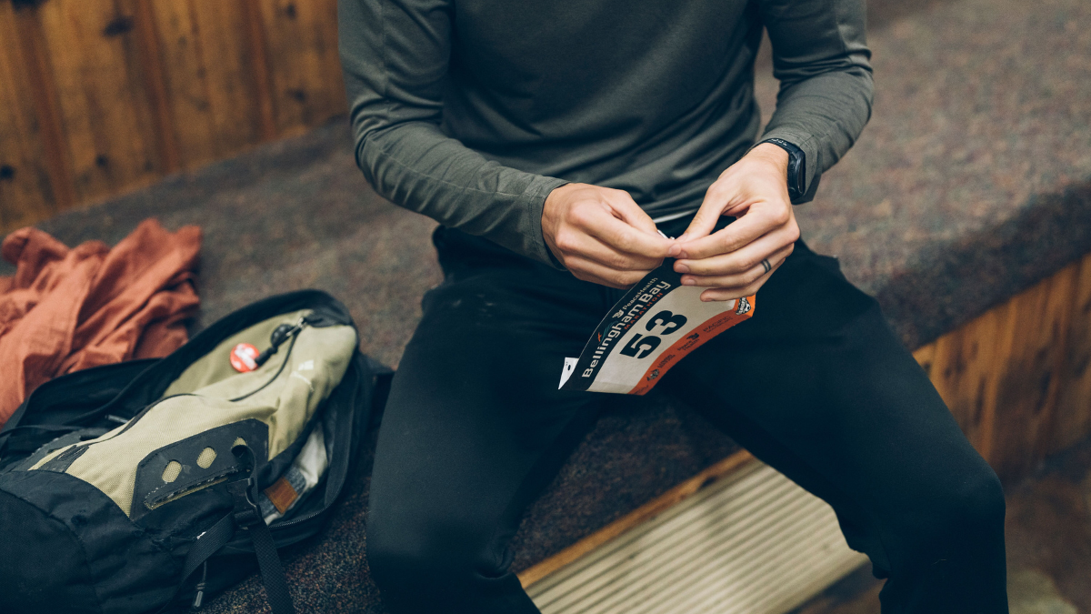 A Runner’s Guide To Race Day Prep Runner Putting On Bib And Preparing For Race