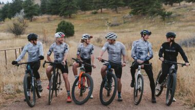 Boundless Coaching team posing for photo on while sitting on bikes in Colorado mountains
