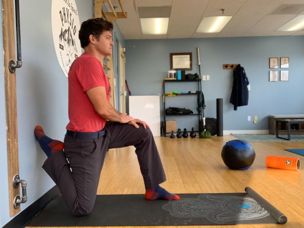 image depicting a man doing knee stretches in order to prevent runner's knee