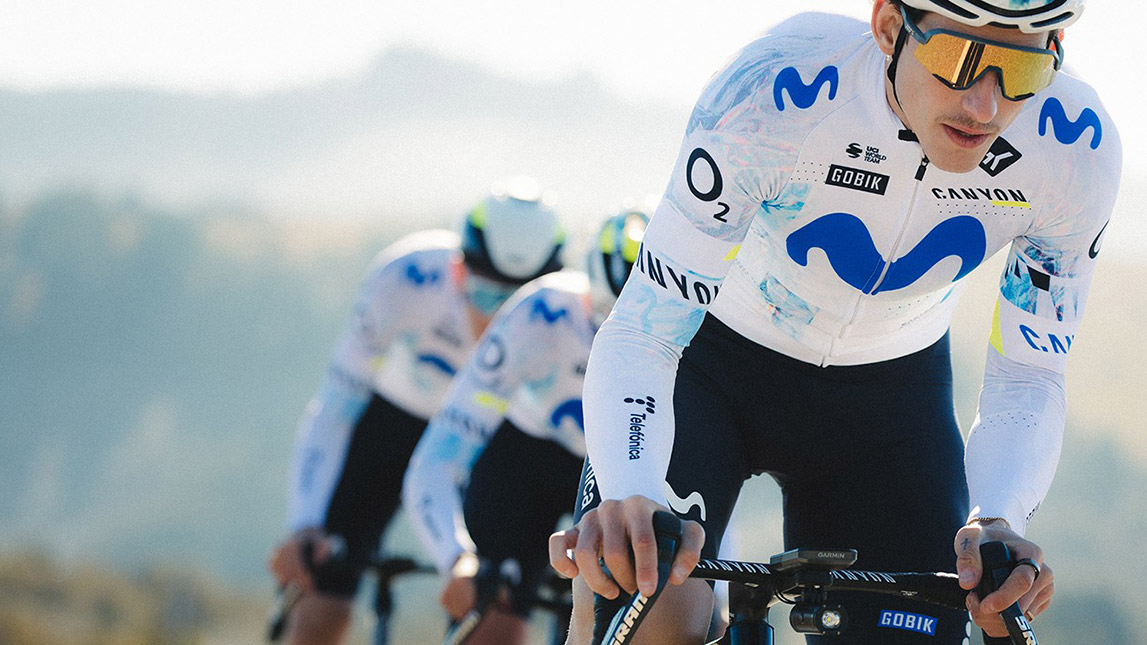 Trainingpeaks And Movistar Male Professional Cyclists Riding Single File Led By Gobik From Team Movistar