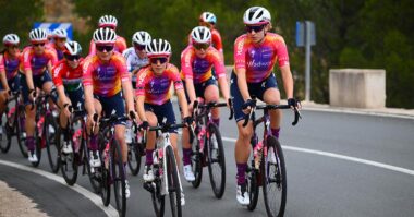 Women's cycling team training in a large group