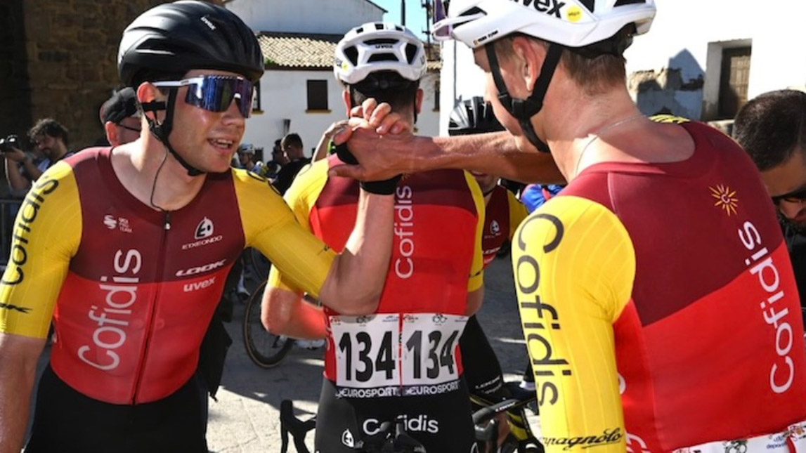 Trainingpeaks And Cofidis Male Professional Cyclists From Team Cofidis Congratulating Each Other With A High Five After A Race