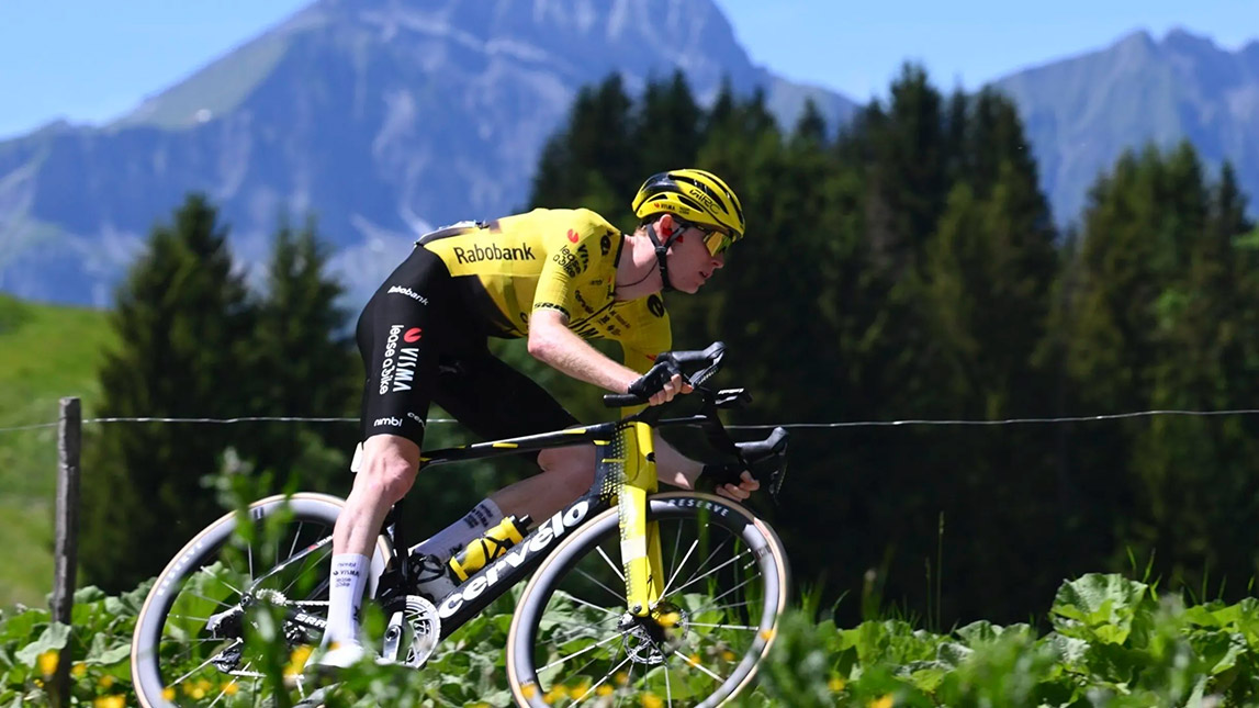 Trainingpeaks And Team Visma Lease A Bike Professional Male Cyclist Riding With Mountains In The Background Team Visma Lease A Bike
