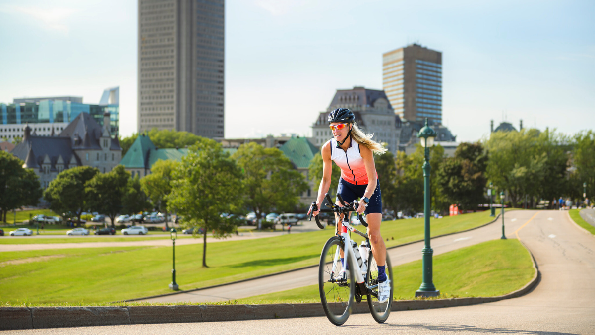 How This Coach Scaled Her Business Female Cyclists On Bike Cycling Outside With City In Background