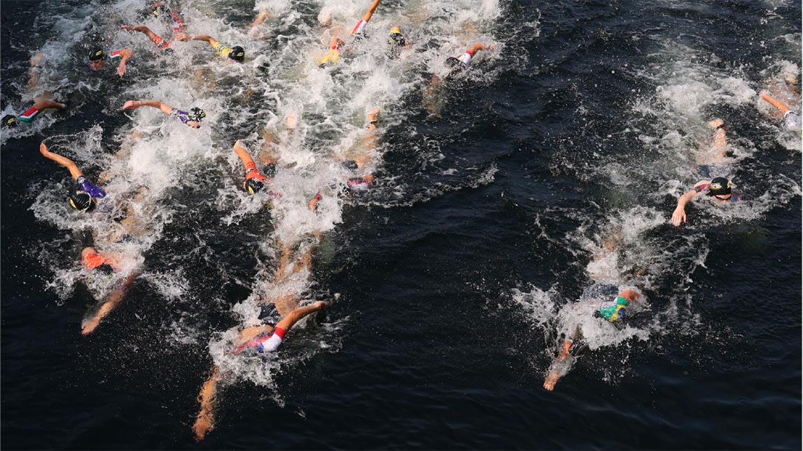 Female Swimmers Racing In Open Water