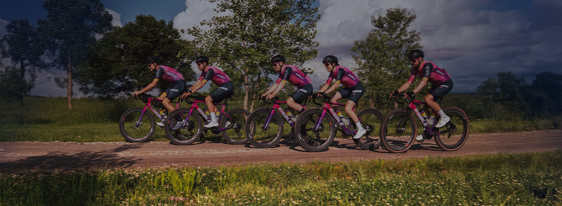 Ribble Outliers And Trainingpeaks Male Professional Cycling Team Training On Country Road Together