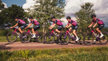 Male professional cycling team training on country road together