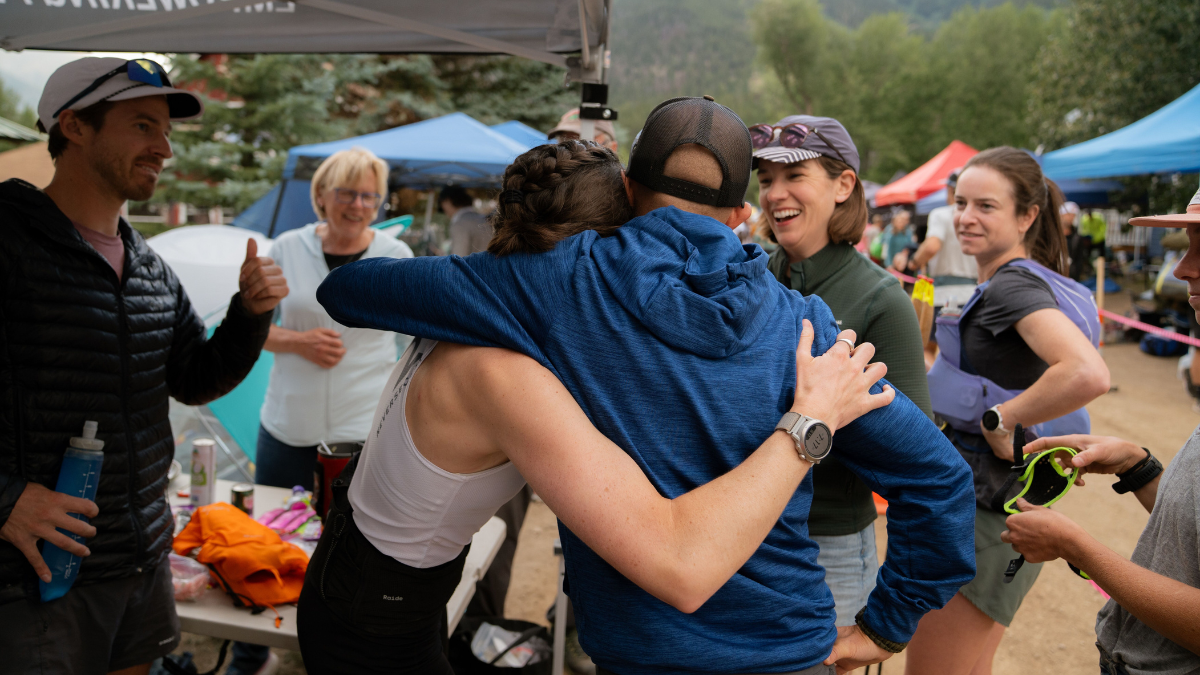 Why You Need A Coach Coach And Athlete Hugging After Endurance Event