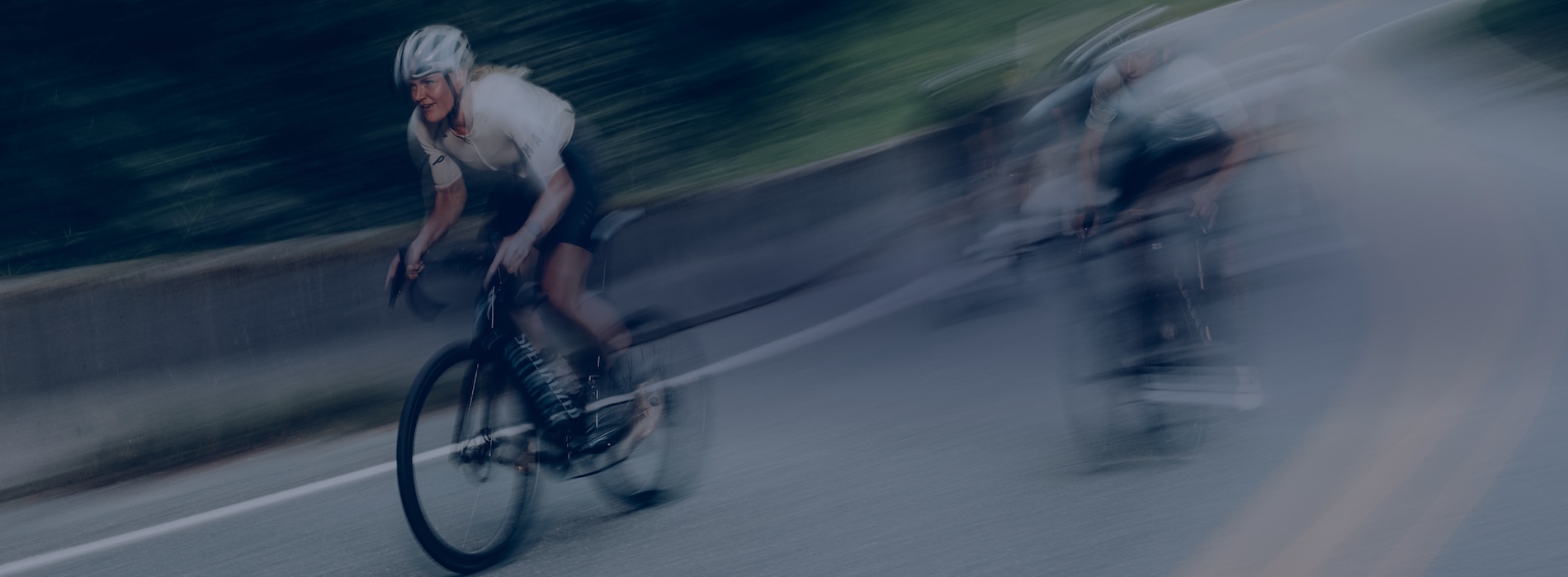 Cyclist Racing On Paved Road