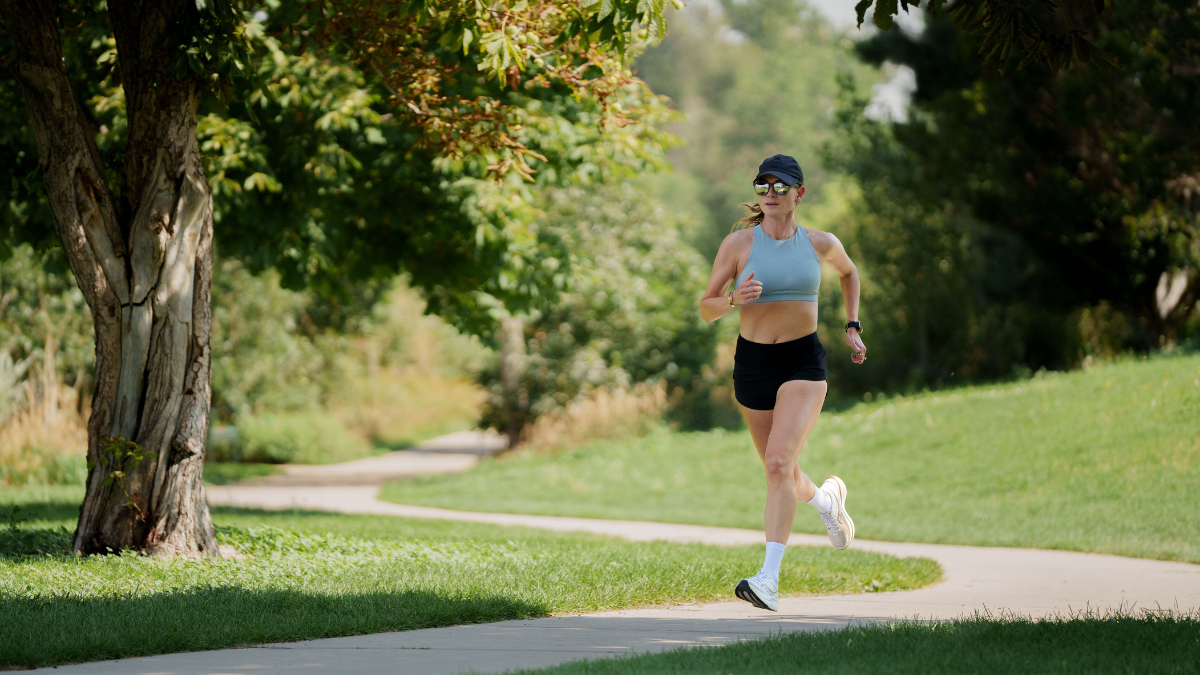 Female Athlete Running On Dirt Road