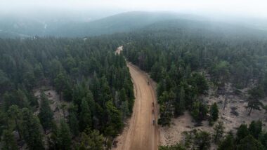 Birds-eye view of Gravel cyclist riding up dirt road in Nederland Colorado