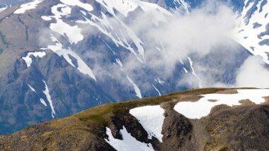 Cirque Series athletes running up snow covered mountain ridge
