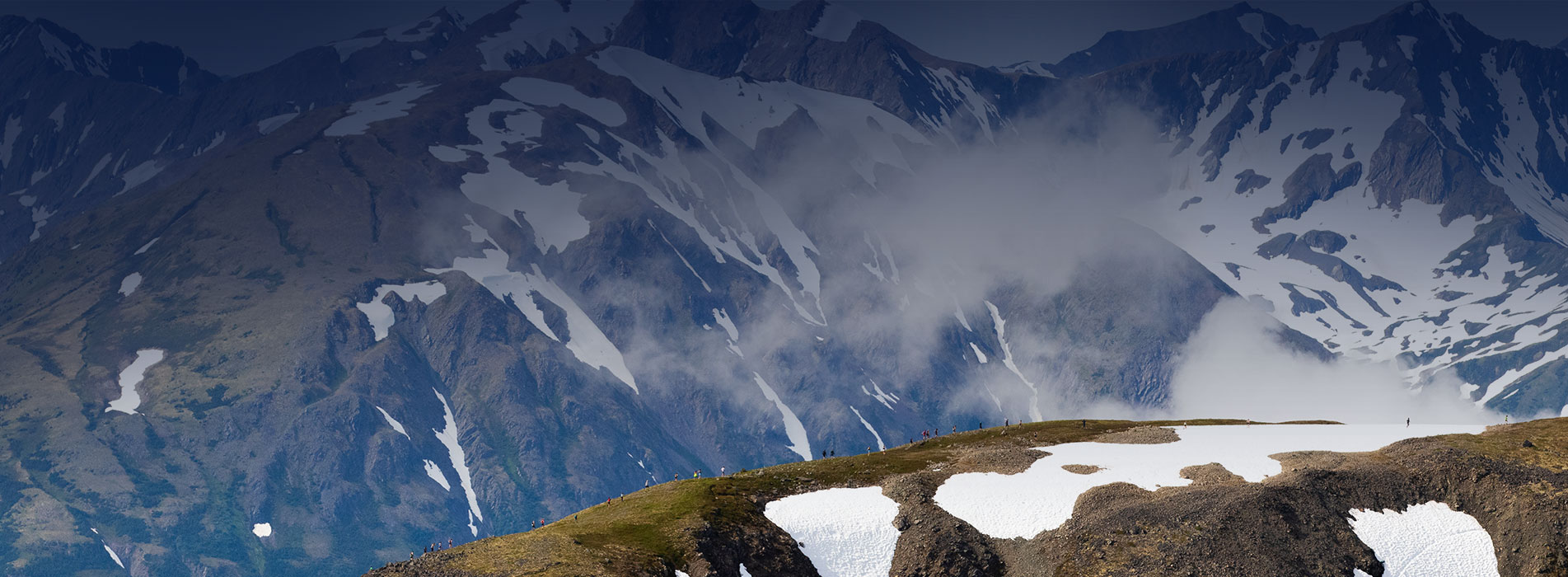 Cirque Series And Trainingpeaks Cirque Series Athletes Running Up Snow Covered Mountain Ridge