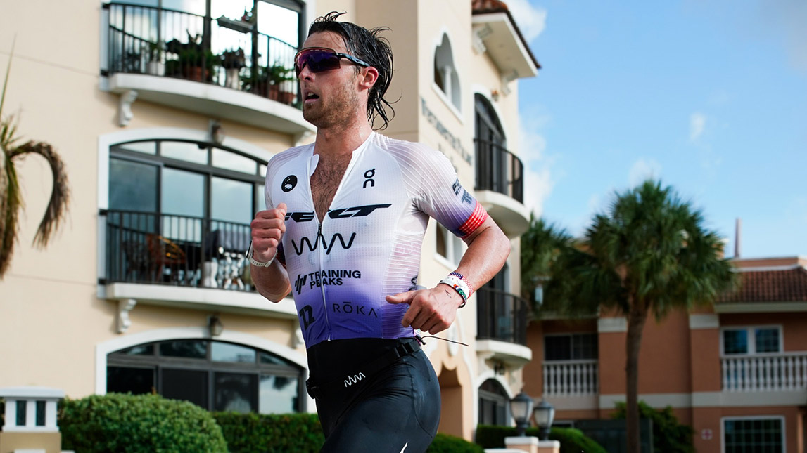 Male Triathlete Trevor Foley Running Through Suburban Neighborhood In Triathlon