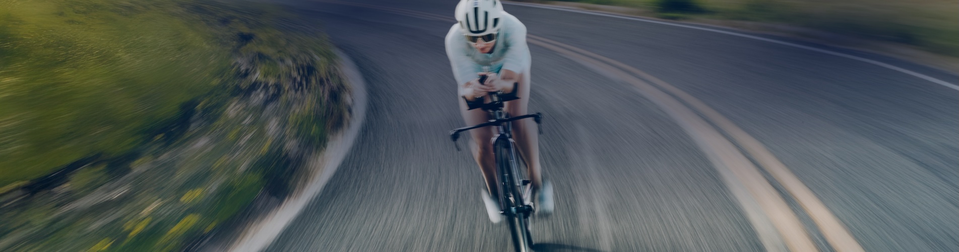 Cyclist Taking A Turn On Paved Road