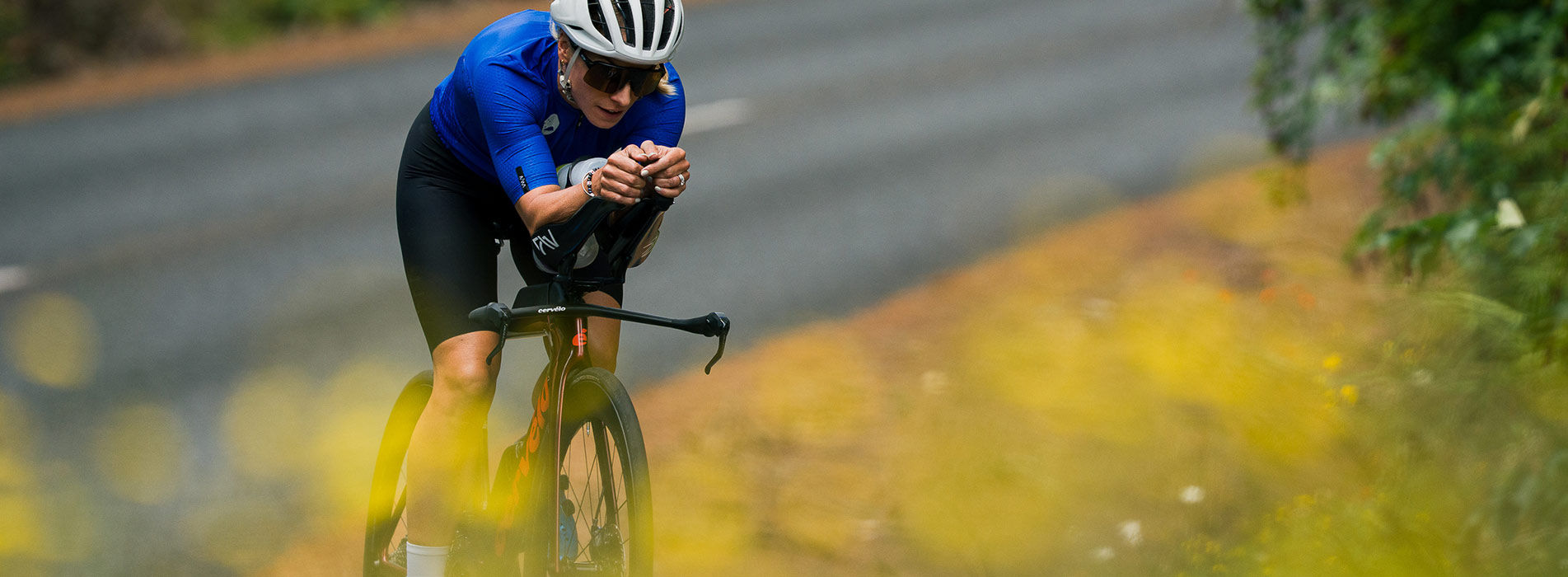 Hannah Berry And Trainingpeaks Female Cyclist Riding Time Trial Bike Down Country Road Hannah Berry And Trainingpeaks