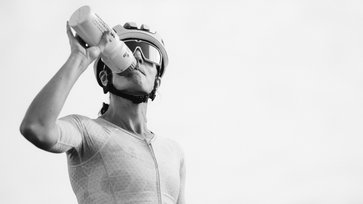 What 34,731 Training Sessions Reveal About Age Group Triathlon Coaching Female Triathlete Drinking Water In Black And White Image