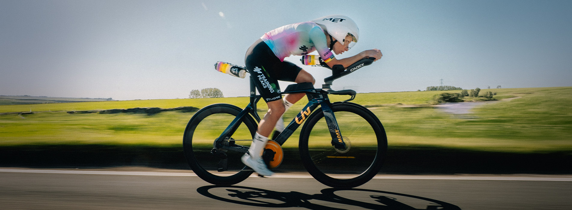 Lizzie Rayner And Trainingpeaks Female Cyclist Riding Time Trial Bike Down Country Side Road Lizzie Rayner