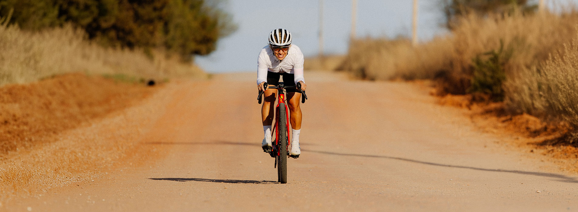 Female Cyclist Riding Down Gravel Road At Mid South Gravel Event Sarah Sturm