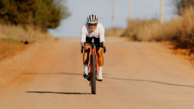Female cyclist riding down gravel road at Mid-South Gravel Event - Sarah Sturm