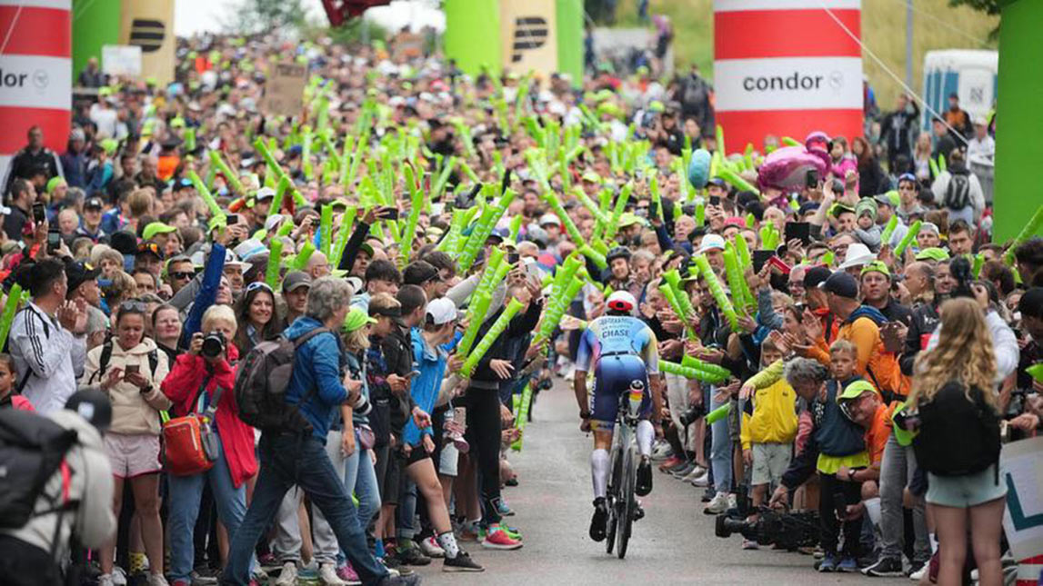 The Real Tri Squad Triathlete Riding Bike Through Cheering Crowd
