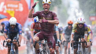 Male road cyclist celebrating across finish line - Modern Adventure Pro Cycling Team