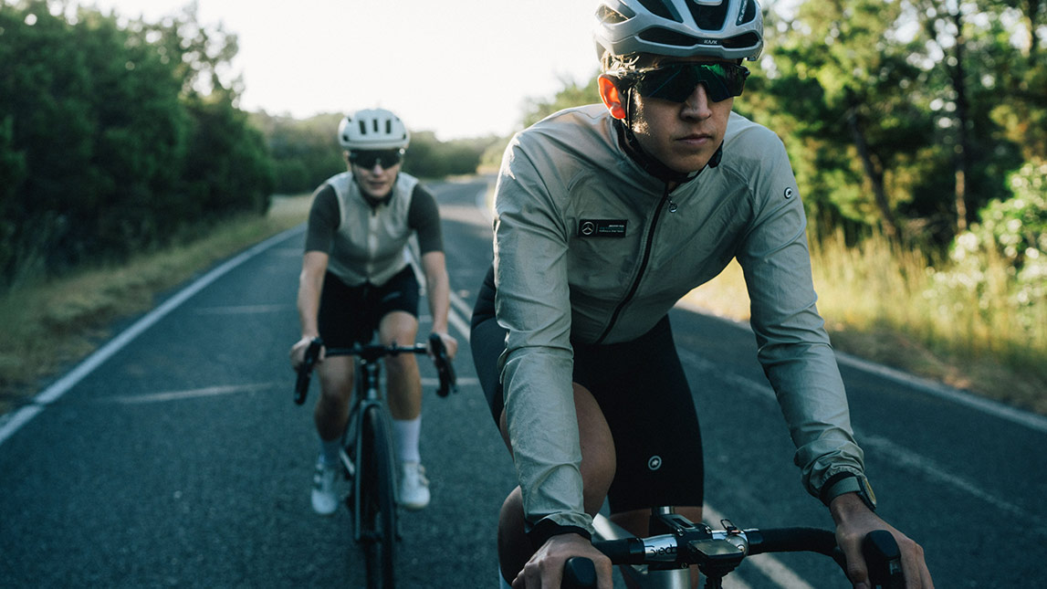 Female, Athlete, Following Her Male, Coach, Cyclists Riding Up The Road Together