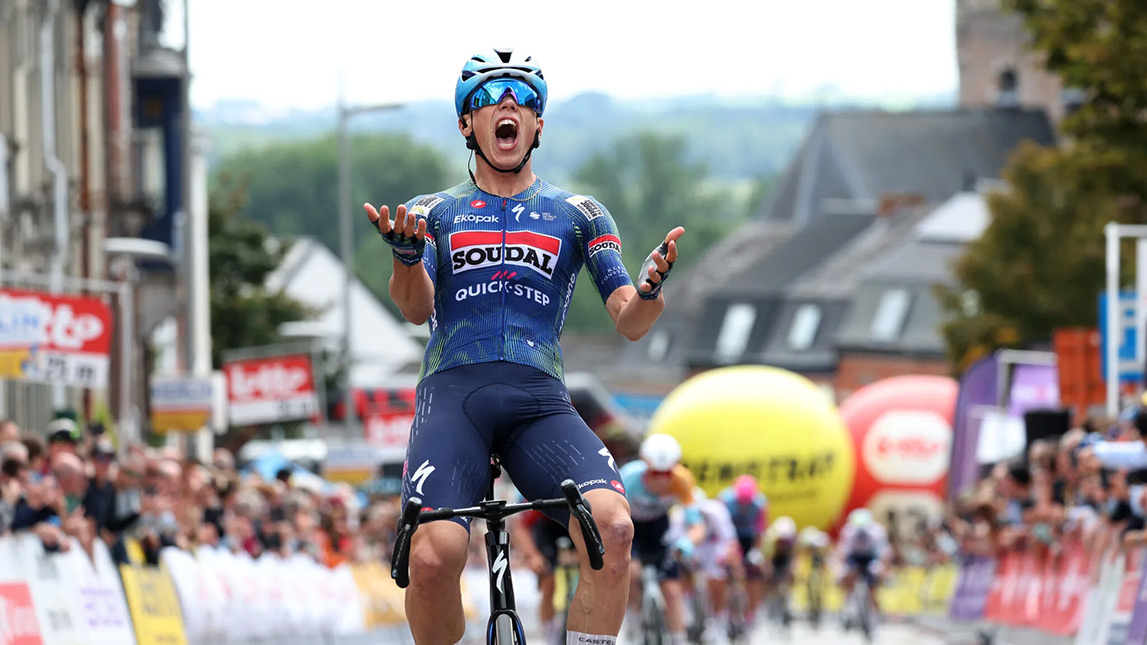 Trainingpeaks And Soudal Quick Step Male Cyclist Crossing Finish Line To Win Race Paul Magnier Muur
