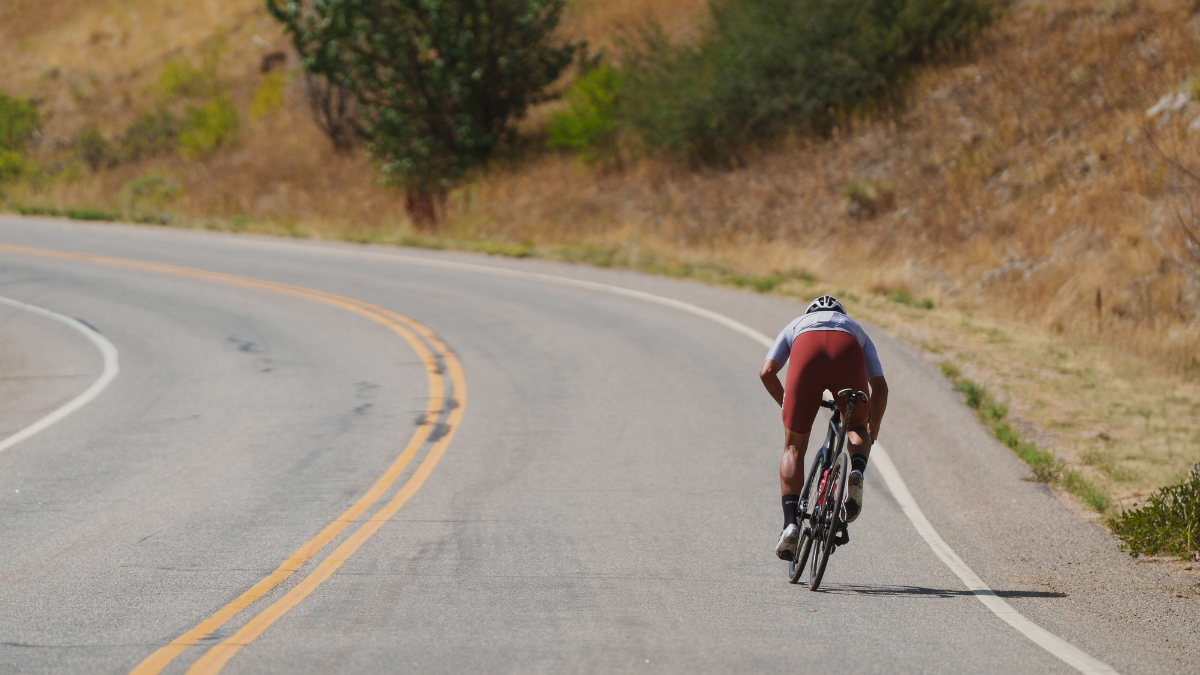 Cyclist Climbing A Hill To Increase Durability And Vo2 Max.