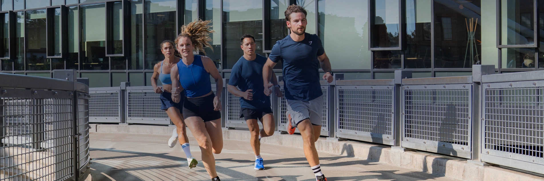 Group Of Runners Running Over A Bridge Group Of Runners Running Over A Bridge